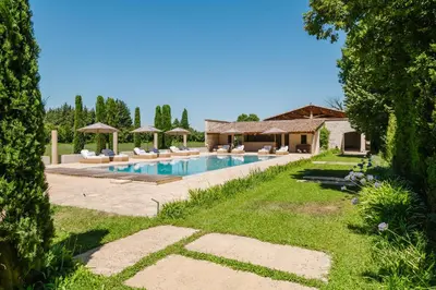 a pool with lounge chairs and a house at Château Saint Perret in Avignon