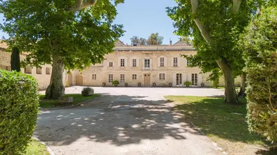 a large building with trees in front of it at Château Saint Perret in Avignon
