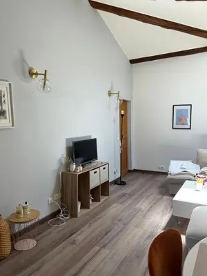 a living room with a flat screen tv on a table at Bel Appartement au 2 eme in Aix-en-Provence