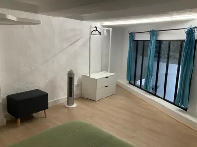 a living room with a dresser and a window at Appartement rénové plein centre in Aix-en-Provence