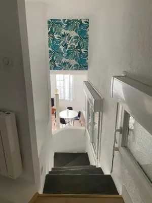 a stairway with a view of a room with a table at Appartement rénové plein centre in Aix-en-Provence