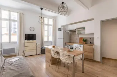a kitchen and living room with a table and chairs at Central studio, perfect for discovering Aix on foot in Aix-en-Provence