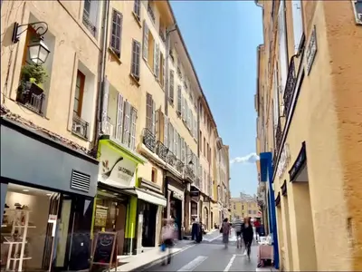 a group of people walking down a street with buildings at Central studio, perfect for discovering Aix on foot in Aix-en-Provence