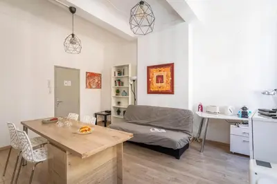 a living room with a couch and a table at Central studio, perfect for discovering Aix on foot in Aix-en-Provence