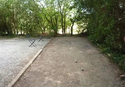 a bench sitting in the middle of a parking lot at Ferme au pied du luberon in Lourmarin
