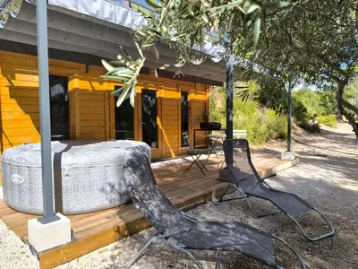 a couple of chairs sitting in front of a house at Evasion sous les pins in Aurons