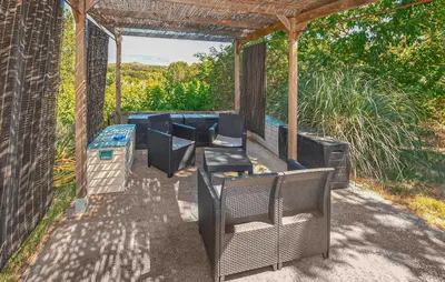 a patio with chairs and a table and a grill at Maison Avec Piscine in La Tour-dʼAigues