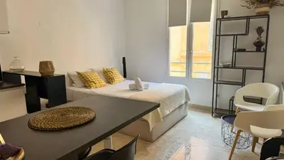 a room with a bed and a table and chairs at Le Calisson, magnifique studio plein centre d'Aix in Aix-en-Provence