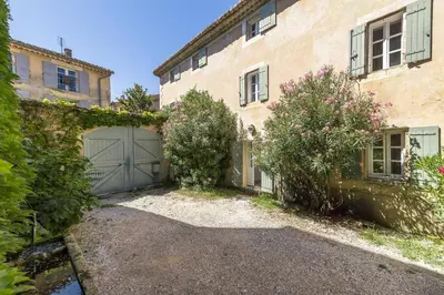 an outdoor dining room with a table and chairs and a pool at LOasis de Gordes Provence Pool Villa Retreat in Gordes
