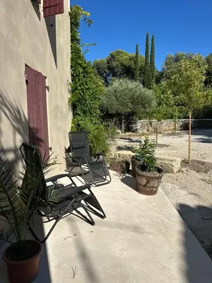 a pair of chairs sitting on a patio at Art Appartement Kristina 80m2 in Graminier