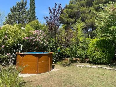 a small dog house in the middle of a garden at Maison provençale avec jardin et piscine à Lambesc in Lambesc