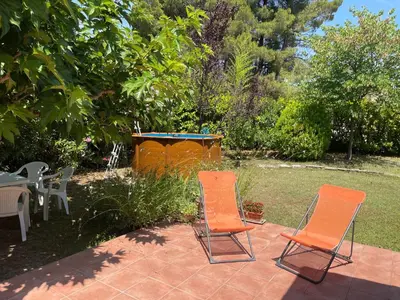 a dog house sitting in the middle of a yard at Maison provençale avec jardin et piscine à Lambesc in Lambesc