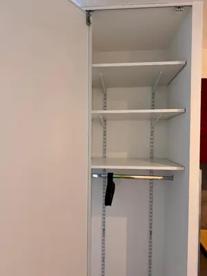 a walk in closet with white shelves at Terrasse, clim et piscine à Aix-en-Provence in Aix-en-Provence