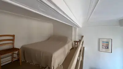 a small bedroom with a bed and a chair at Un cocon au cœur de Aix in Aix-en-Provence
