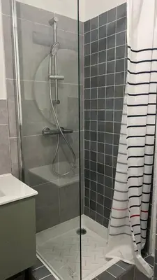 a shower with a glass door in a bathroom at Un cocon au cœur de Aix in Aix-en-Provence