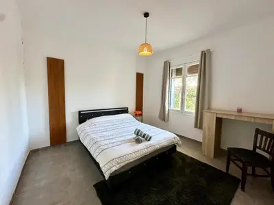 a bedroom with a bed and a window at Villa Maguy - Piscine et jardin privée - Proche centre ville Aix en Provence - Parking - Boulodrome - Plancha in Aix-en-Provence