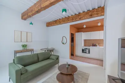 a living room with a couch and a table at Appartement Belle Lettre 7 in Aix-en-Provence