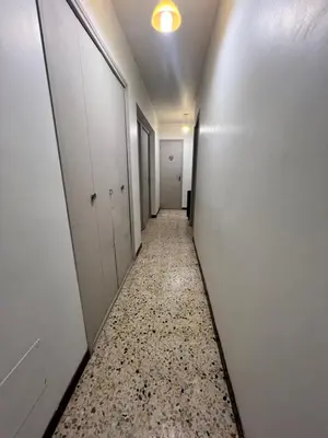 an empty corridor in an office building with a long hallway at La maison de Raffi in La Tour-dʼAigues