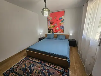 a bedroom with a bed and a painting on the wall at Villa sous les pins in Ventabren