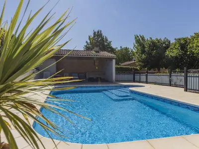 a swimming pool in a yard with a fence at Villa A l'Ombre du Soleil by Interhome in Monteux