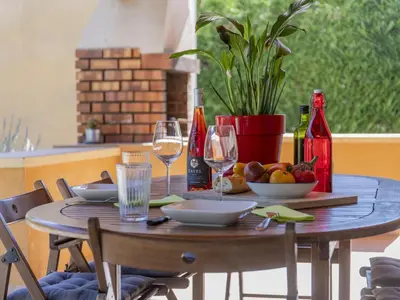 a table with wine glasses and a bowl of fruit at Villa A l'Ombre du Soleil by Interhome in Monteux