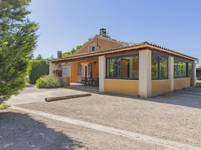 a small yellow house with a lot of windows at Villa A l'Ombre du Soleil by Interhome in Monteux