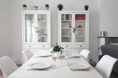a white dining room with a white table and white chairs at T2 Centre historique d'Aix-en-Provence in Aix-en-Provence