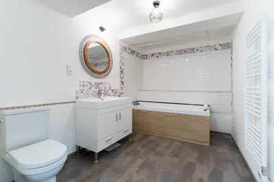 a bathroom with a toilet and a sink and a tub at Maison de village chaleureuse in Sainte-Tulle