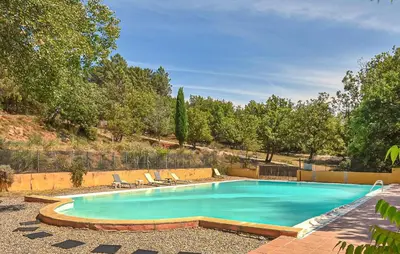 a swimming pool with two lounge chairs next to it at Maison Avec Piscine in Villars