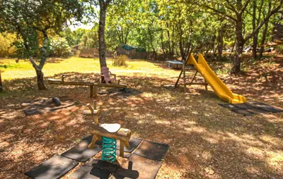 a park with a playground with a slide at Maison Avec Piscine in Villars