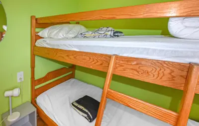 two bunk beds in a green room with a book at Maison Avec Piscine in Villars
