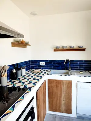 a kitchen with blue and white tiles on the wall at Le Picholine in Mazan