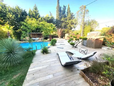 a backyard with two lounge chairs and a pool at Pasca'land in Velaux