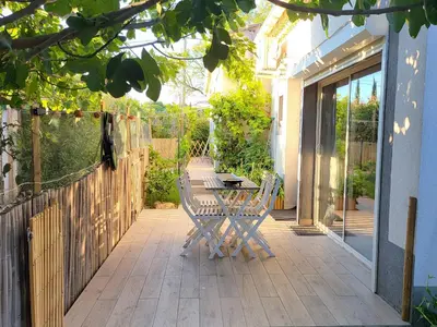 a patio with a table and chairs and a fence at Pasca'land in Velaux