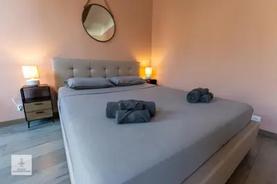 a bedroom with a large bed with towels on it at Maison des Chaudronniers in Aix-en-Provence