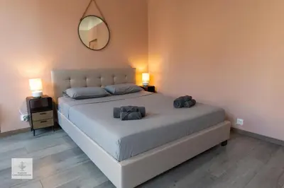 a bedroom with a bed with two pillows and a mirror at Maison des Chaudronniers in Aix-en-Provence