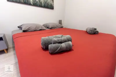 a bedroom with a bed with a red blanket at Maison des Chaudronniers in Aix-en-Provence