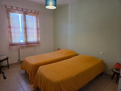 two beds in a room with a window at Villa avec piscine privée in Alleins