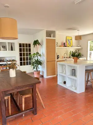 a kitchen with a table and a dining room at Lourmarin Family Country House in Cadenet