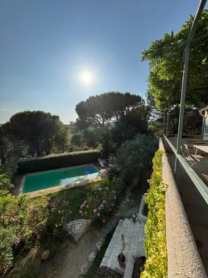 a swimming pool in a garden with flowers at Lourmarin Family Country House in Cadenet