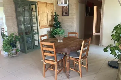 a wooden table and chairs in a room with plants at Villa Caromb - Mont Ventoux Garden - by TGB in Caromb
