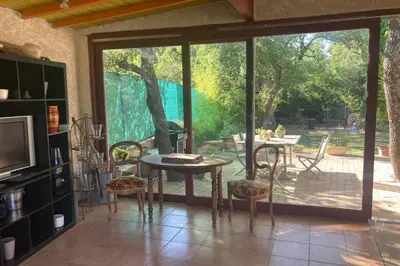 a dining room with a table and a sliding glass door at Villa Caromb - Mont Ventoux Garden - by TGB in Caromb