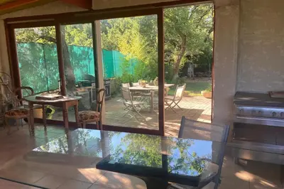 a conservatory with a glass table and a piano at Villa Caromb - Mont Ventoux Garden - by TGB in Caromb