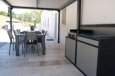 a kitchen with a table and a table and chairs at Luxury air-conditioned villa pool views Aix-en-Provence LS7-457 in Saint-Cannat