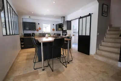 a kitchen with a table and some chairs in a room at Luxury air-conditioned villa pool views Aix-en-Provence LS7-457 in Saint-Cannat