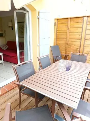 a wooden table and chairs on a patio at Domaine de Pont royal in Mallemort