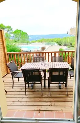 a patio with a table and chairs on a deck at Domaine de Pont royal in Mallemort