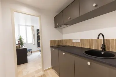 a kitchen with a sink and a counter top at Suite Lueur de Sable - Hypercentre - WiFi in Apt