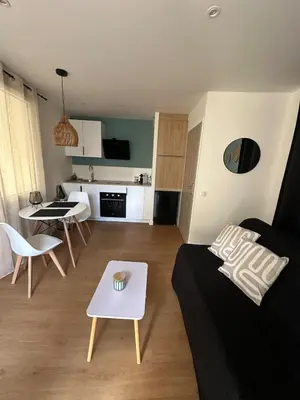 two chairs and a table in front of a door at L'Échappée Belle Studio in Châteaurenard