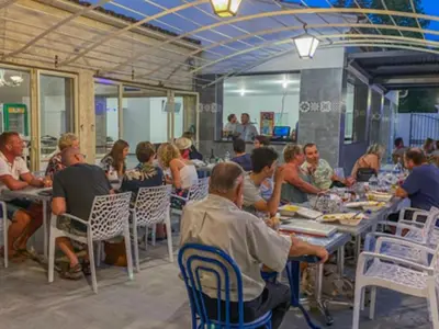 a group of people sitting at tables in a restaurant at Chalet 46m² avec Terrasse à Noves - API-1-52-531 in Noves